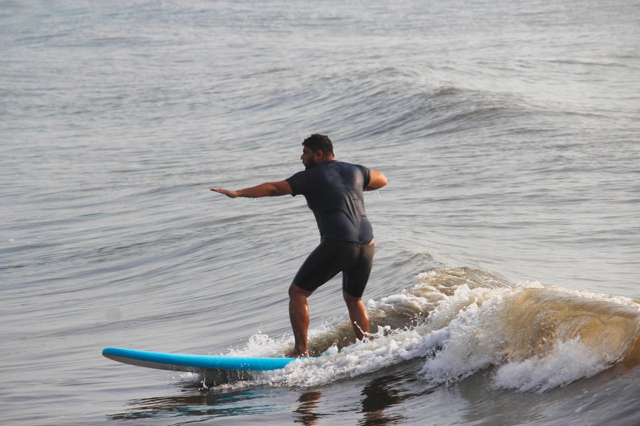 Surfer trimming along a breaking wave