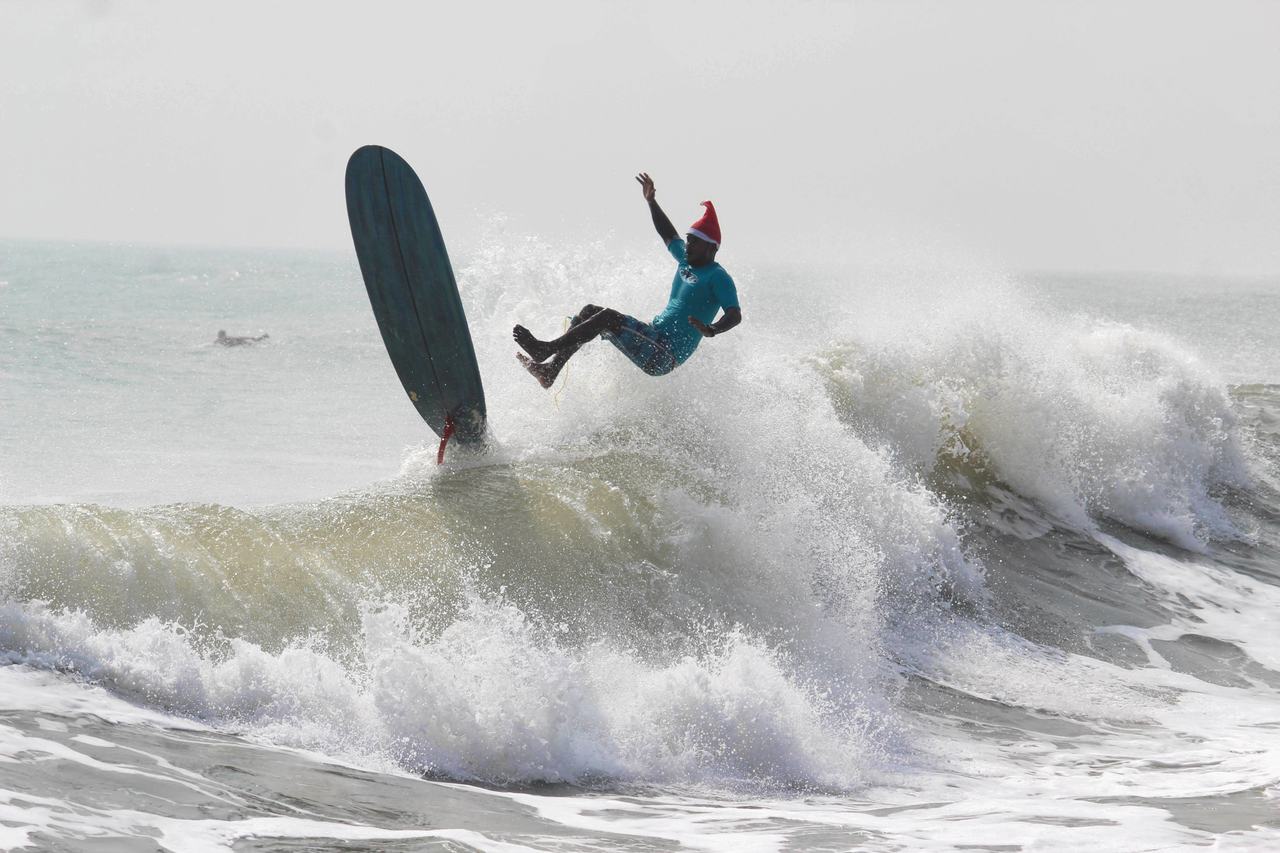 Surfer kicking out over a breaking wave